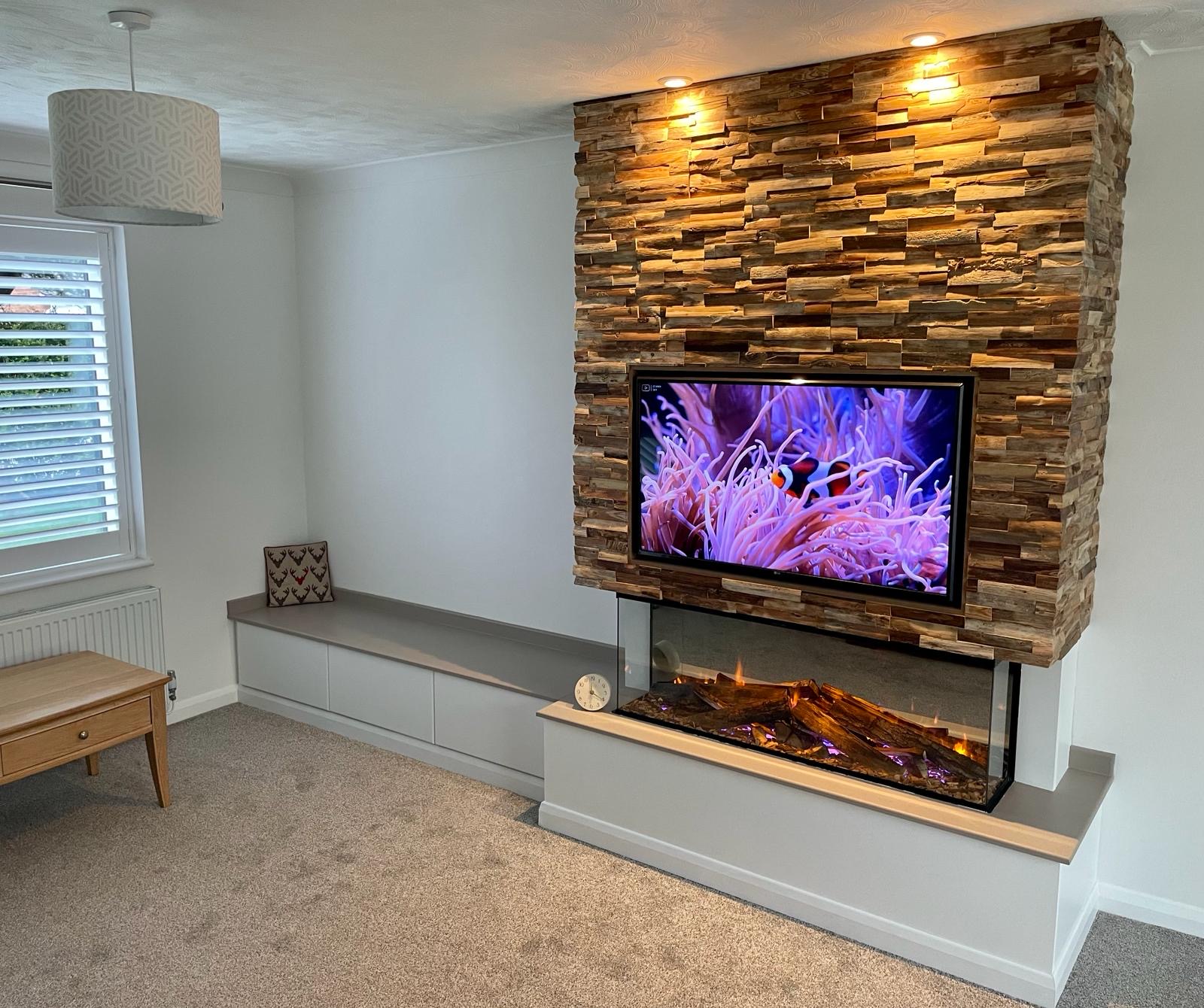 Media wall clad in split-face timber with a TV, an inset fire and a built-in bench seat
