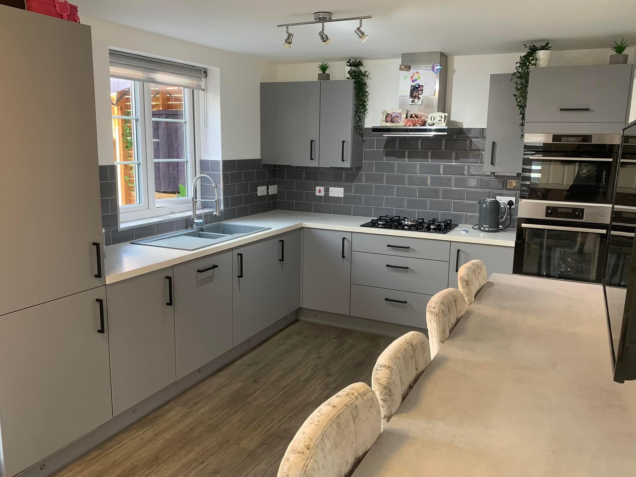 Grey shaker-style kitchen with a long breakfast bar