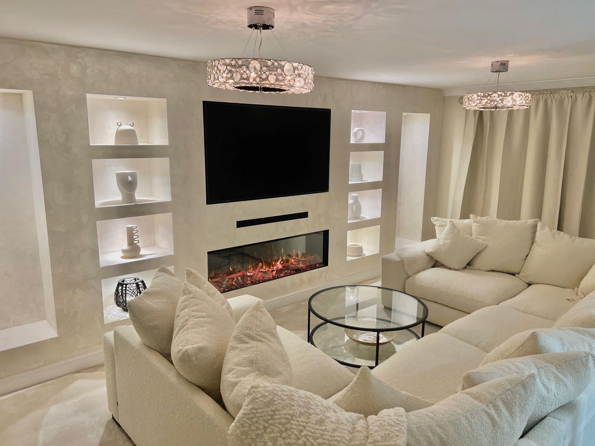 Media wall with lit display niches either side of a TV and a long inset electric fire